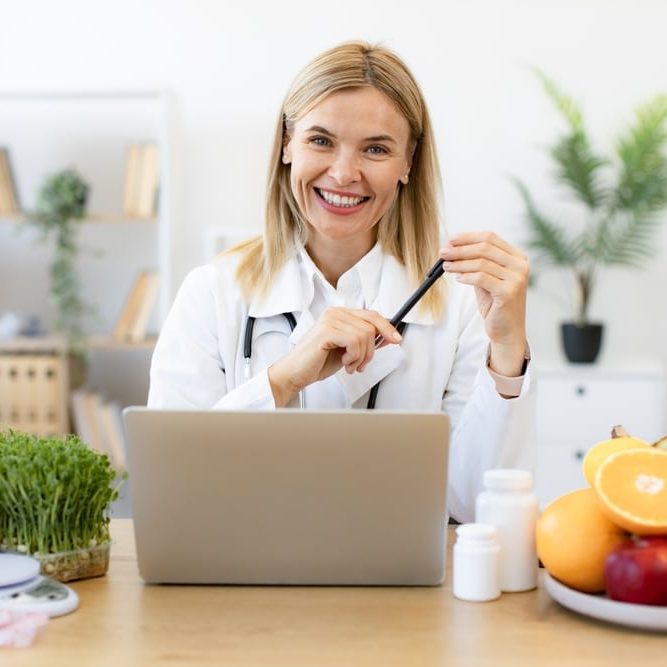 Mature,Dietitian,Working,With,Laptop,Computer,Making,Balanced,Corrective,Diet